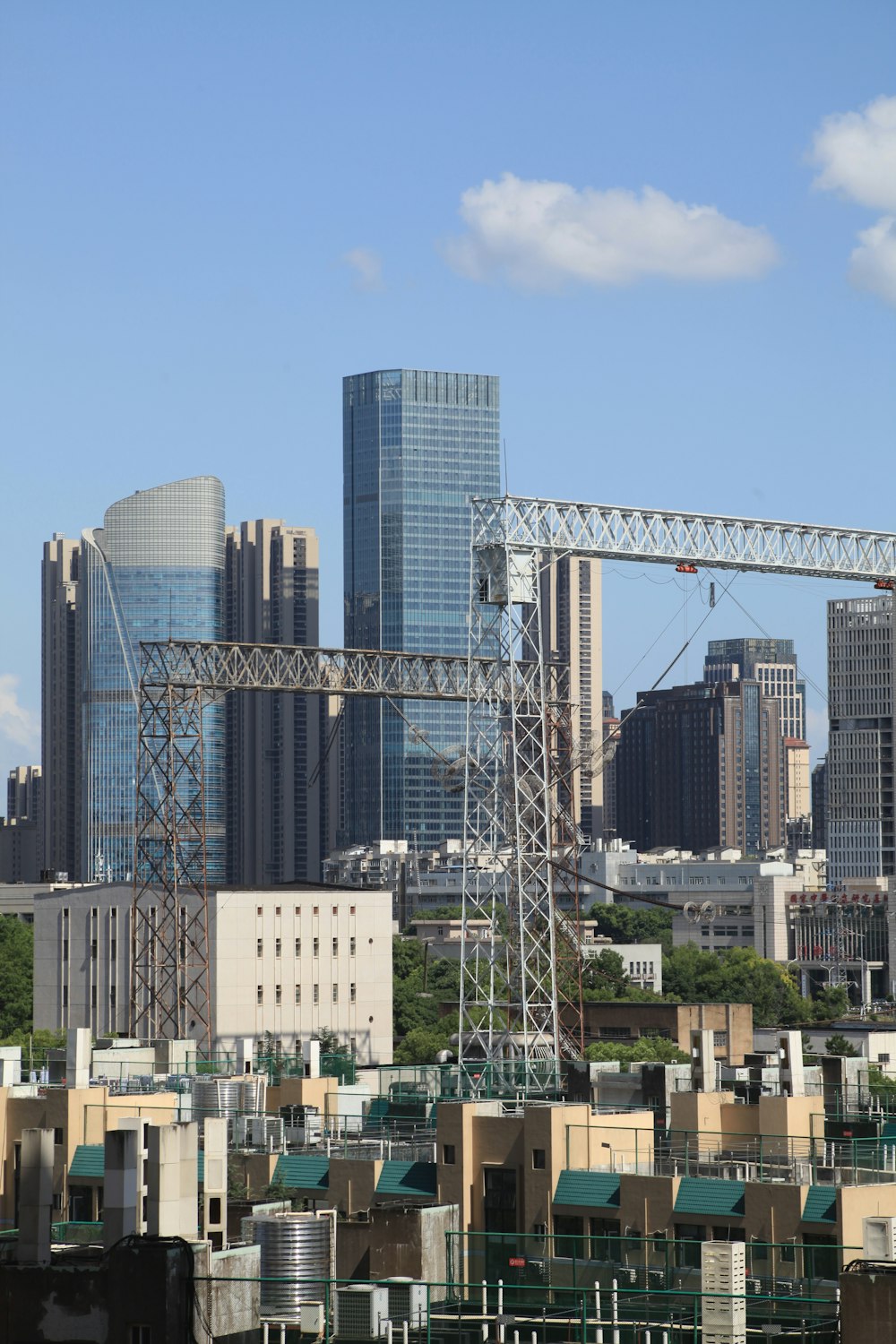 a city skyline with a crane in the foreground