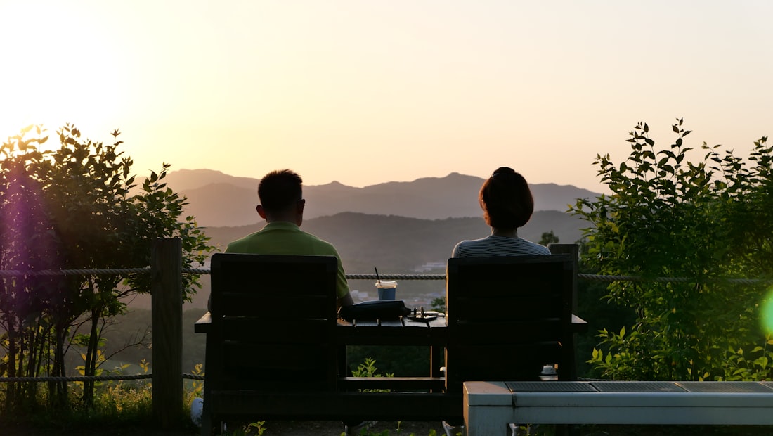 Two people seated together on a private deck, watching the light go