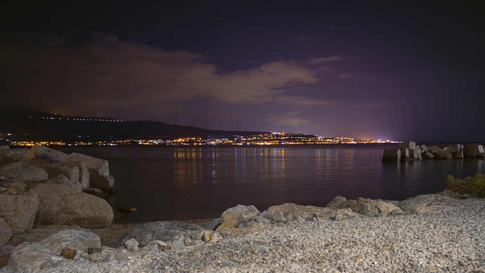 a body of water with a city in the background