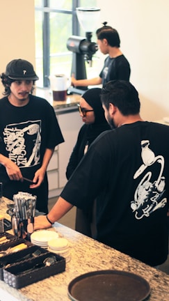 Team members discussing job openings with clients over coffee.