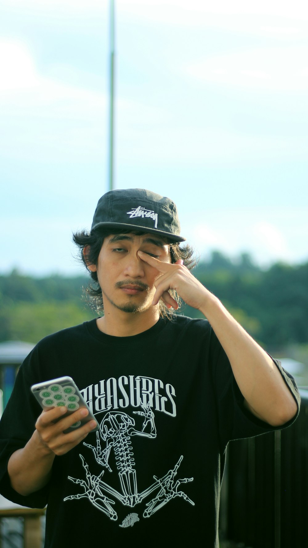 a young man holding a cell phone to his ear