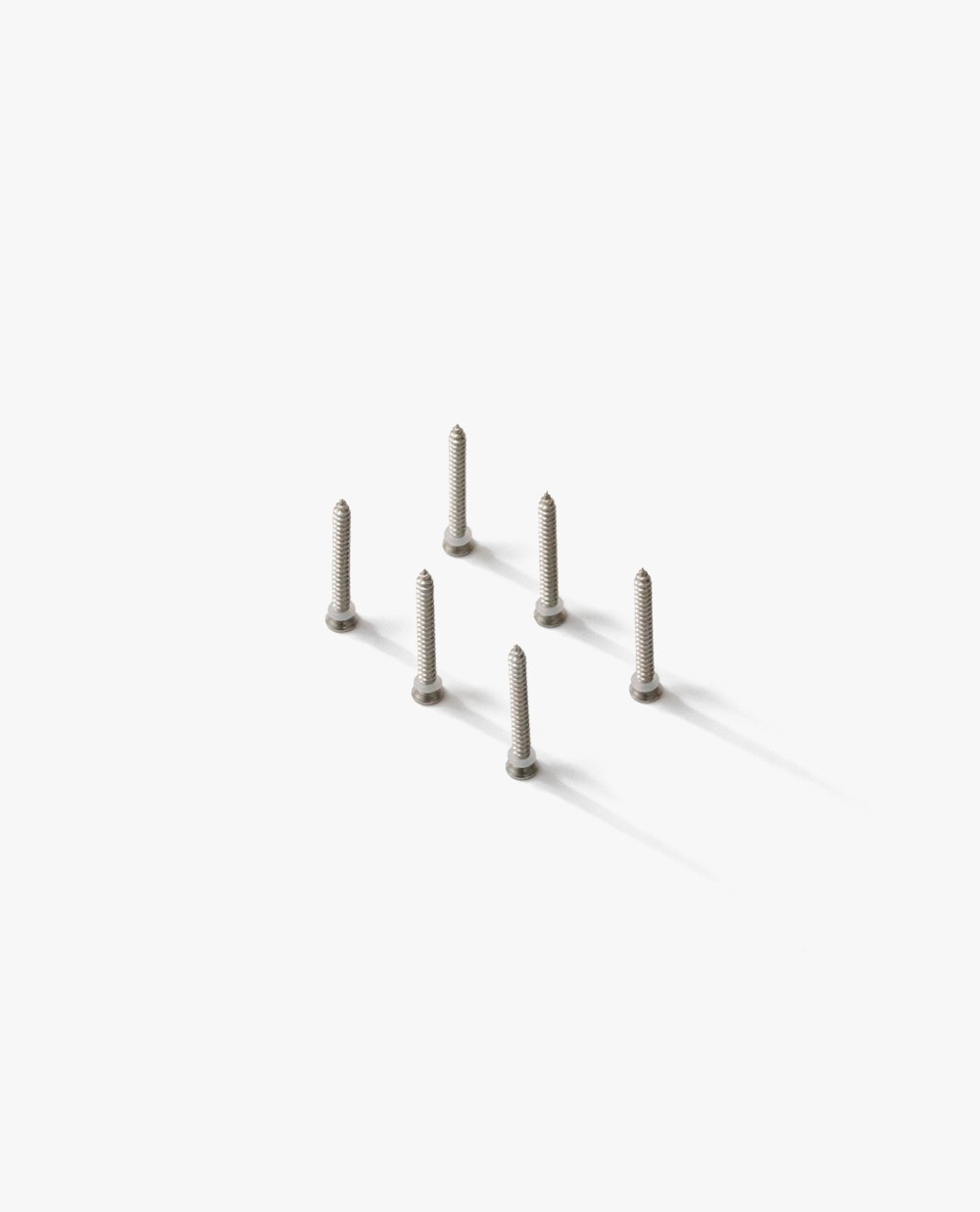 a group of screws sitting on top of a white surface