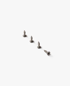 A set of mounting brackets and screws laid out on a clean white surface.