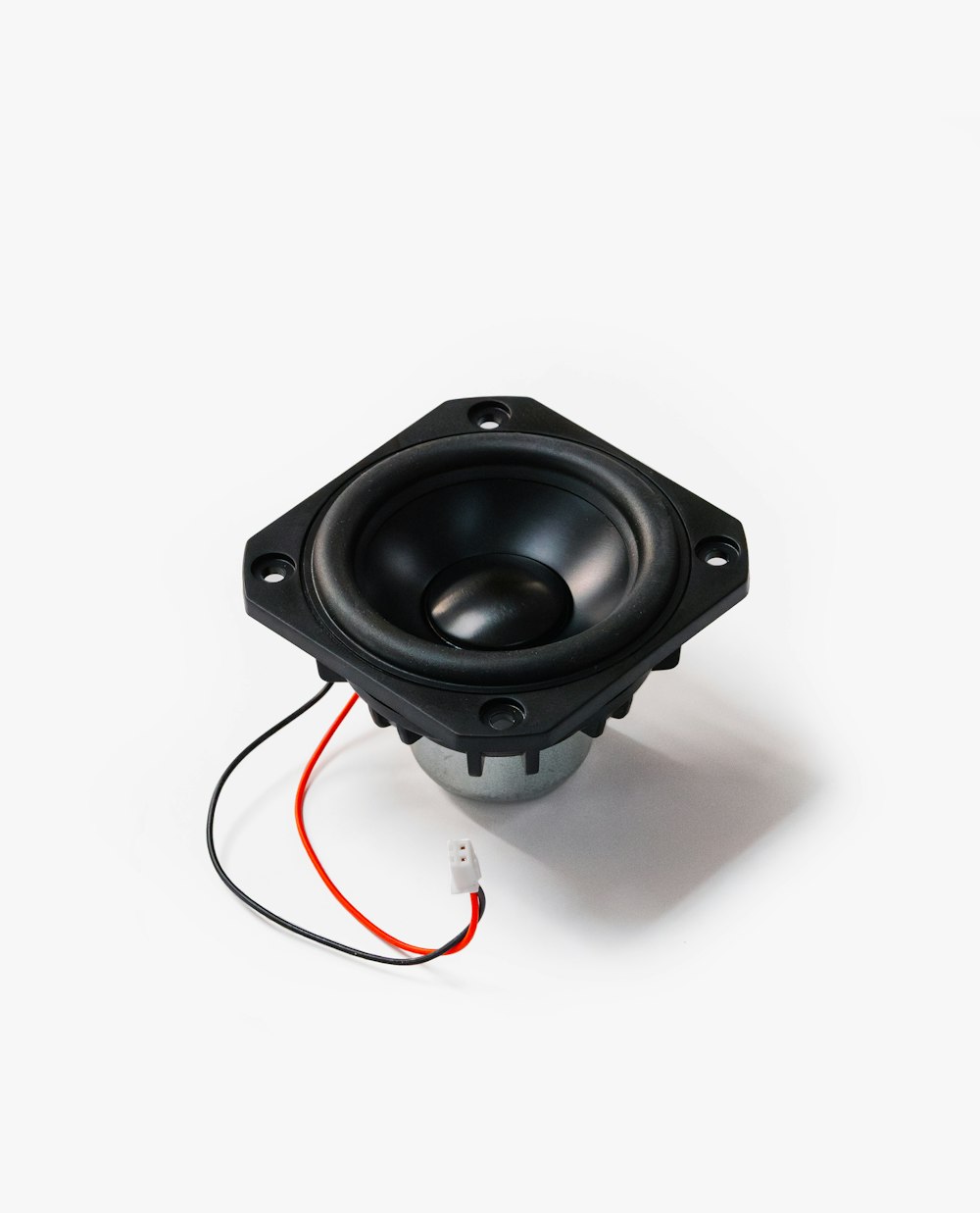 a speaker with a red wire attached to it