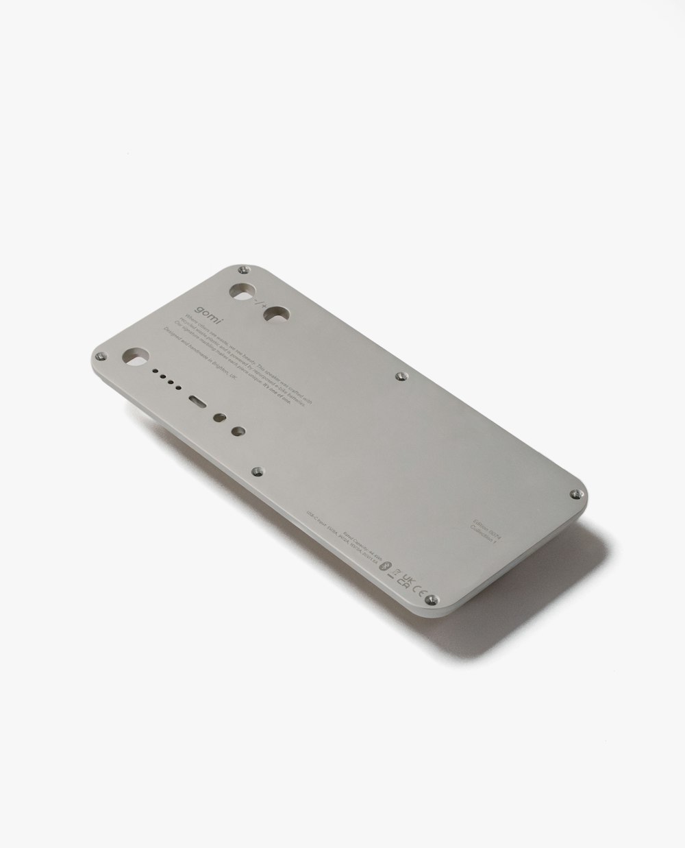 the back of a cell phone on a white surface