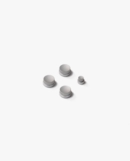 a group of white buttons sitting on top of a white surface