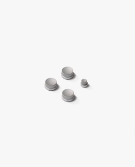 a group of white buttons sitting on top of a white surface
