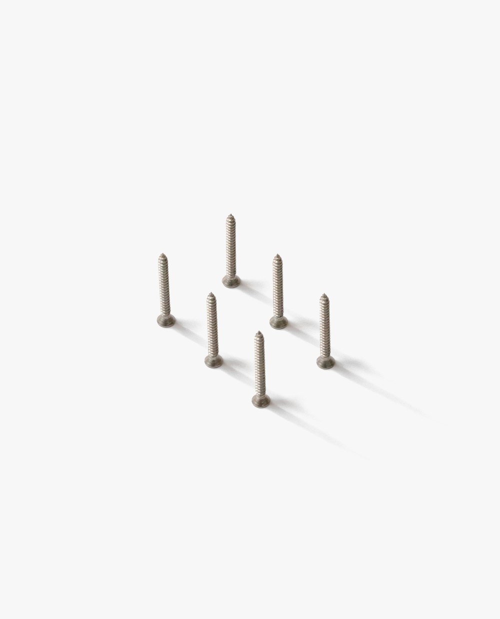 a group of screws sitting on top of a white surface