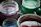 A colorful assortment of slime jars with various textures and vibrant hues displayed on a wooden table.