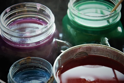 A close-up of various solvents in clear containers.