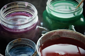 Close-up of colorful chemical compounds in jars.