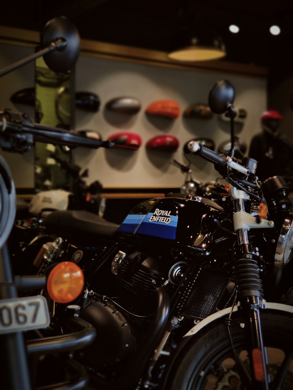 a black motorcycle parked in a garage next to a wall