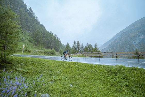 A cyclist riding through a lush green landscape in Ecuador.