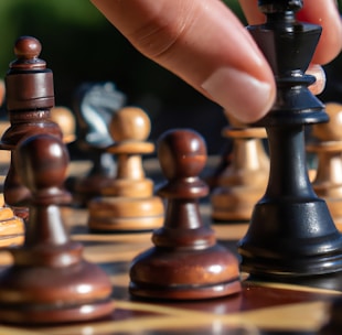 a close up of a person playing chess