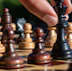 a close up of a person playing chess