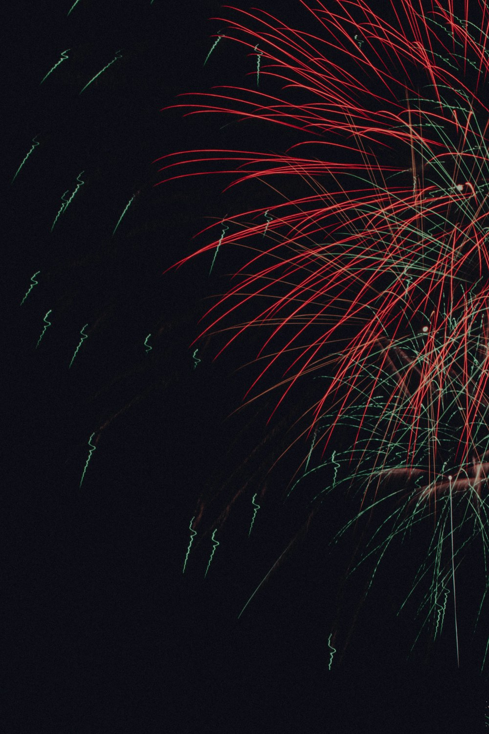 a large fireworks is lit up in the night sky