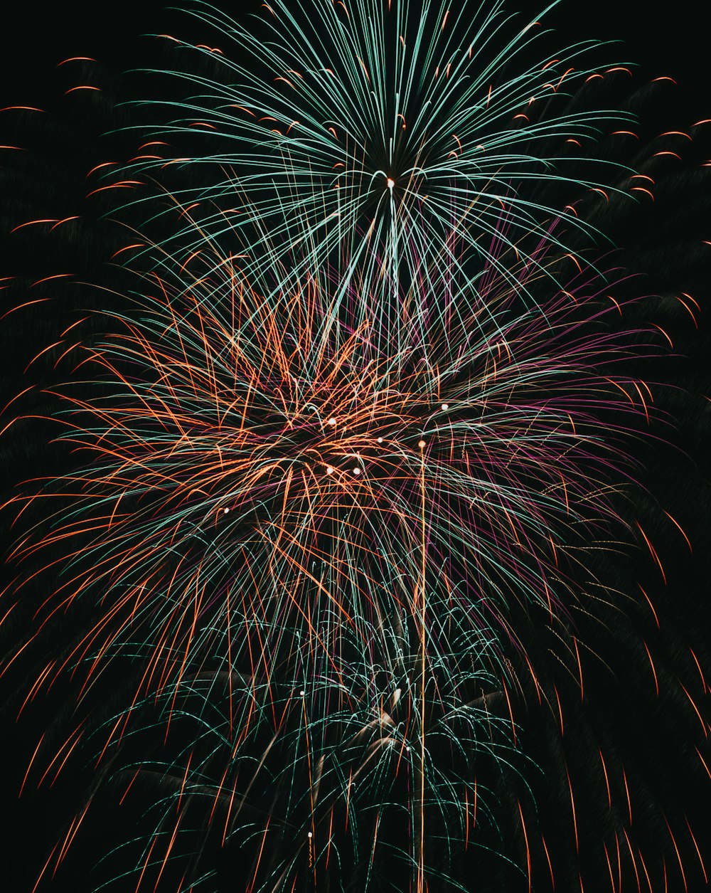 a large fireworks is lit up in the night sky