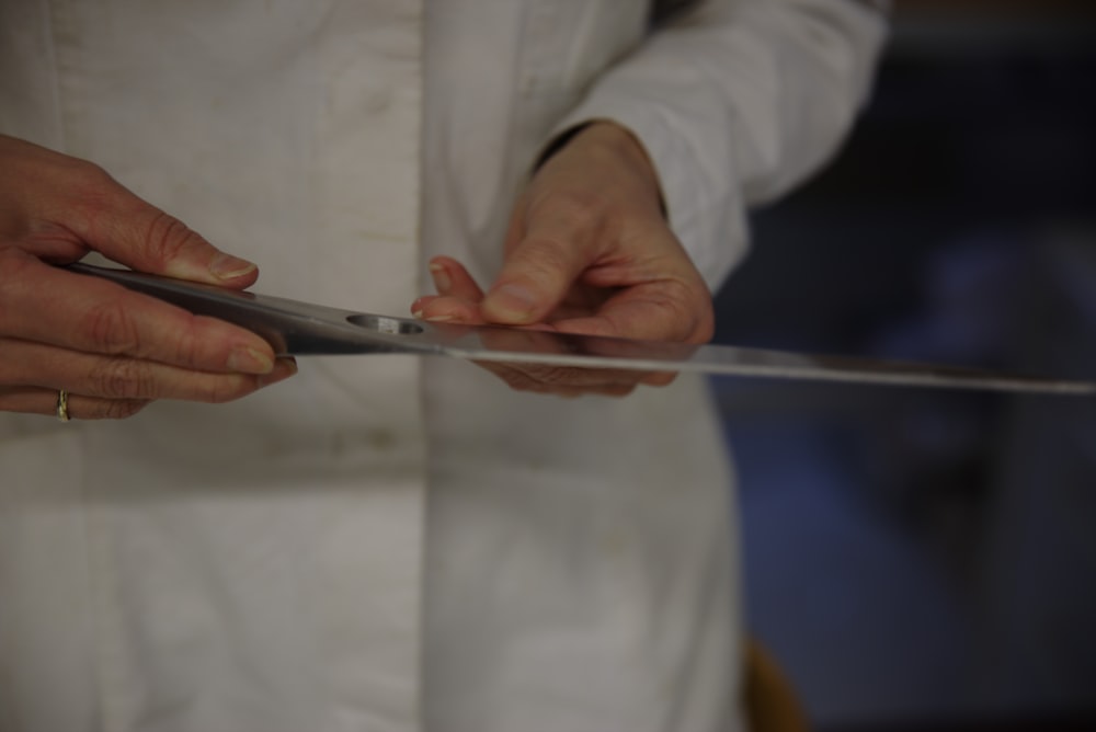 a close up of a person cutting something with a pair of scissors