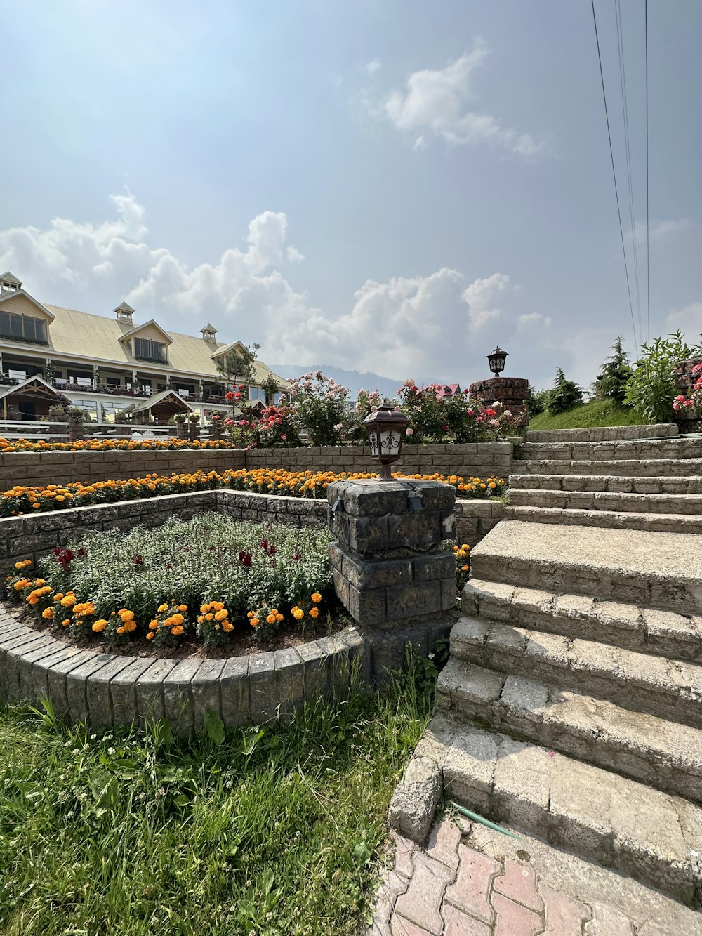 a circular flower bed in the middle of a stone wall