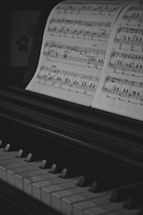 a piano with sheet music sitting on top of it