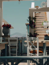 Inviting outdoor seating area surrounded by greenery and mountain views.