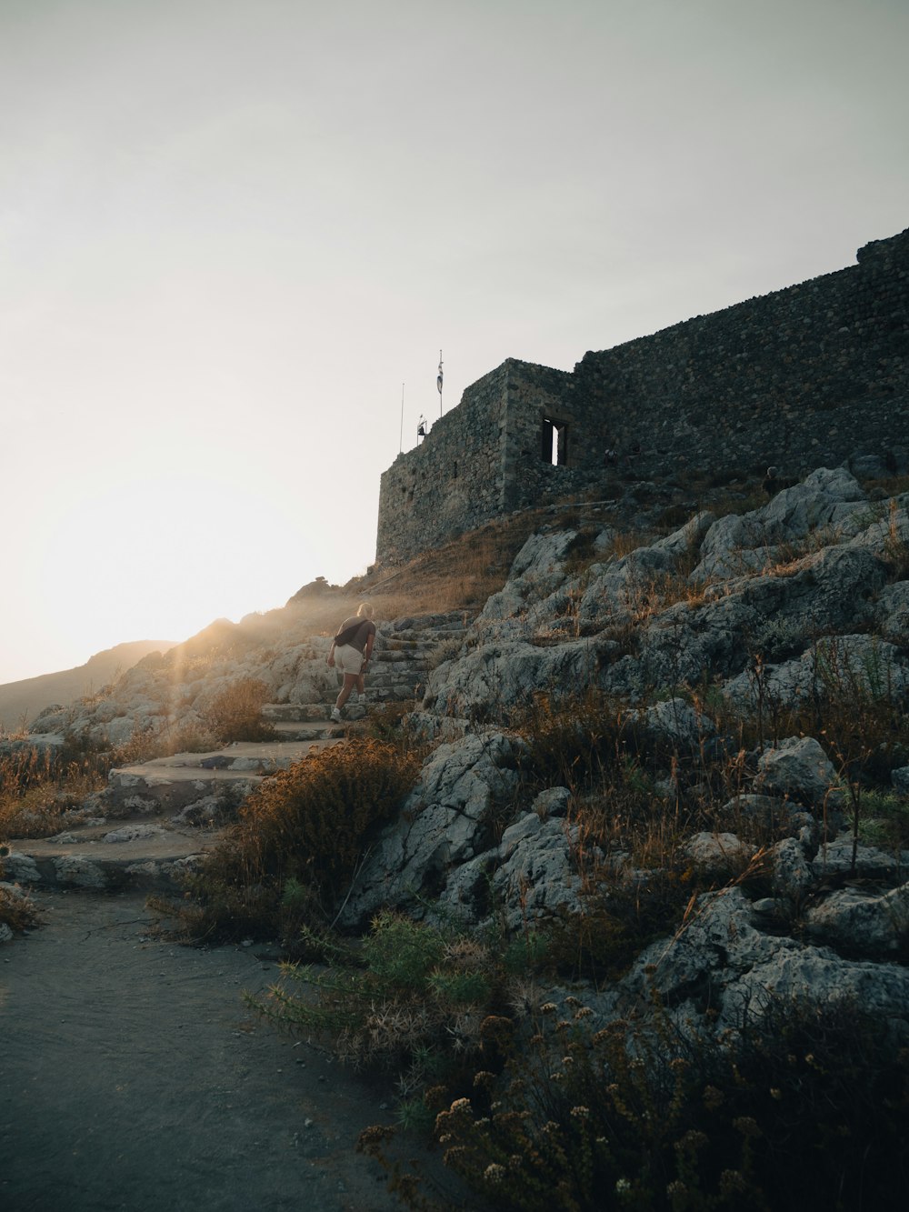 a stone building sitting on top of a rocky hill