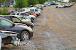 Damaged vehicles left in a storage lot, illustrating customer complaints.