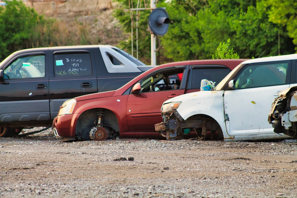 a couple of cars that are sitting in the dirt