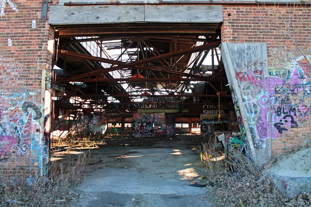 an old brick building with graffiti on it