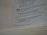 A close-up view of an open book displaying text from a religious or spiritual scripture with numbered verses. The text is formatted with bold numbers indicating specific sections or verses, and includes phrases referencing divine declarations.