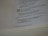 A close-up view of an open book displaying text from a religious or spiritual scripture with numbered verses. The text is formatted with bold numbers indicating specific sections or verses, and includes phrases referencing divine declarations.