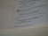 A close-up view of an open book displaying text from a religious or spiritual scripture with numbered verses. The text is formatted with bold numbers indicating specific sections or verses, and includes phrases referencing divine declarations.