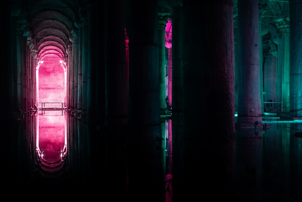 a dark room with a pink light in the middle