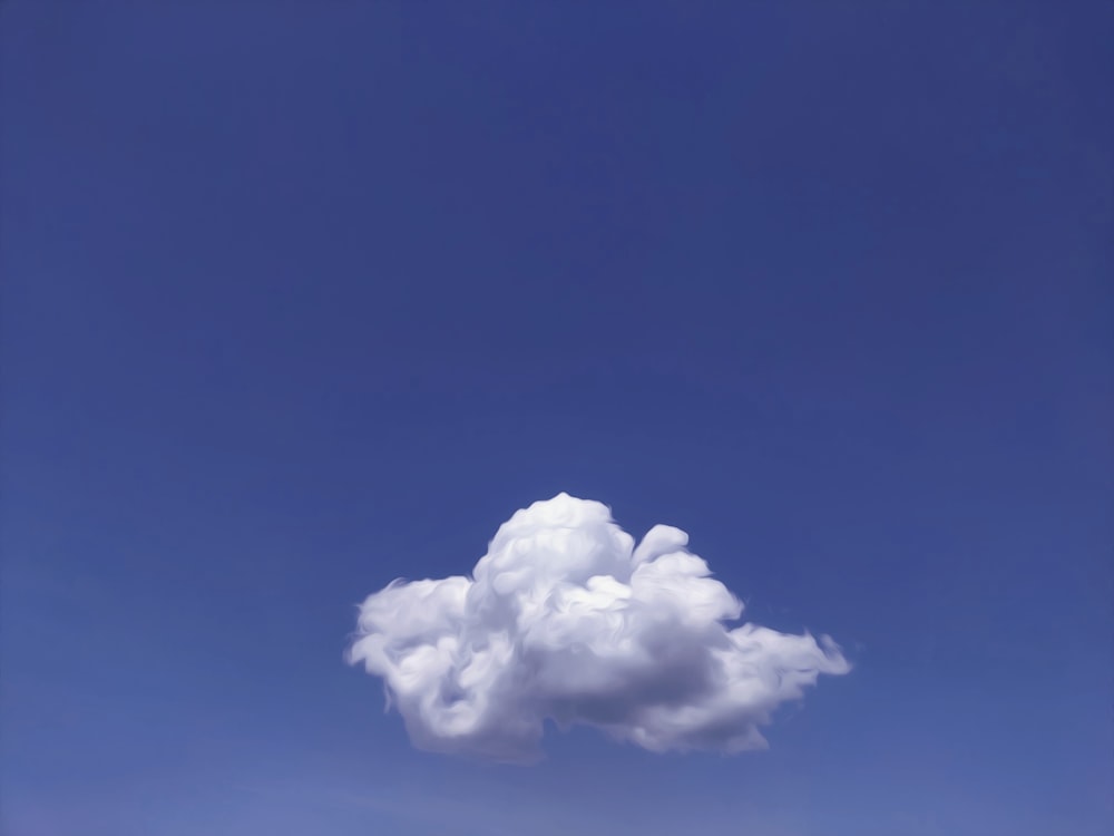 a white cloud floating in a blue sky