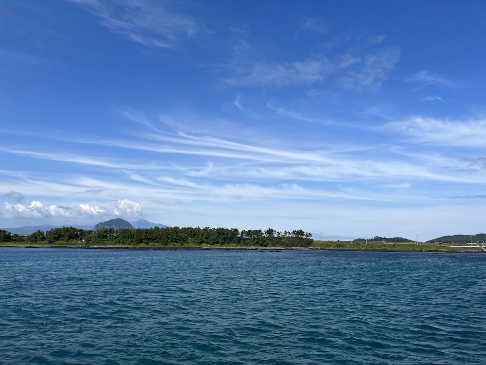 a body of water with a small island in the distance