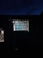 Evening shot of a Moroccan home illuminated with warm light, secured by an electronic lock.