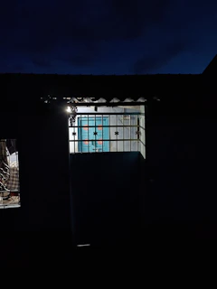 Evening shot of a Moroccan home illuminated with warm light, secured by an electronic lock.