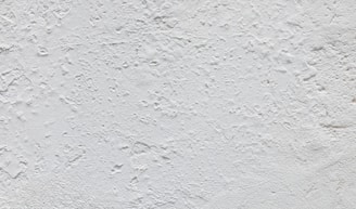 Close-up of a textured UV wall print showing intricate patterns on a tile surface.