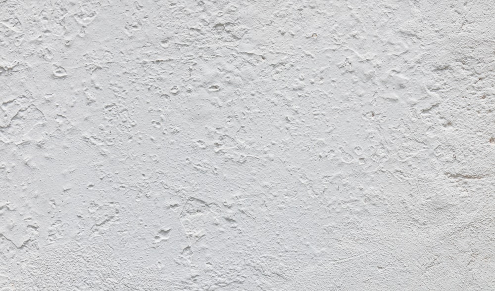 a white stucco wall with white paint on it