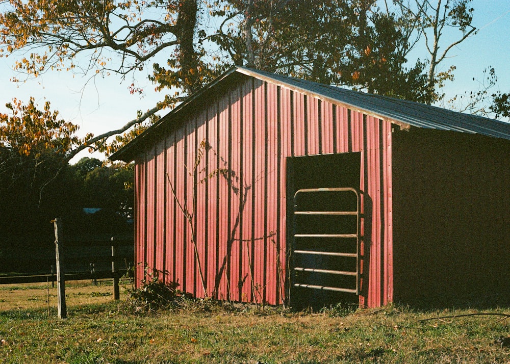 a red barn with a ladder leaning against it