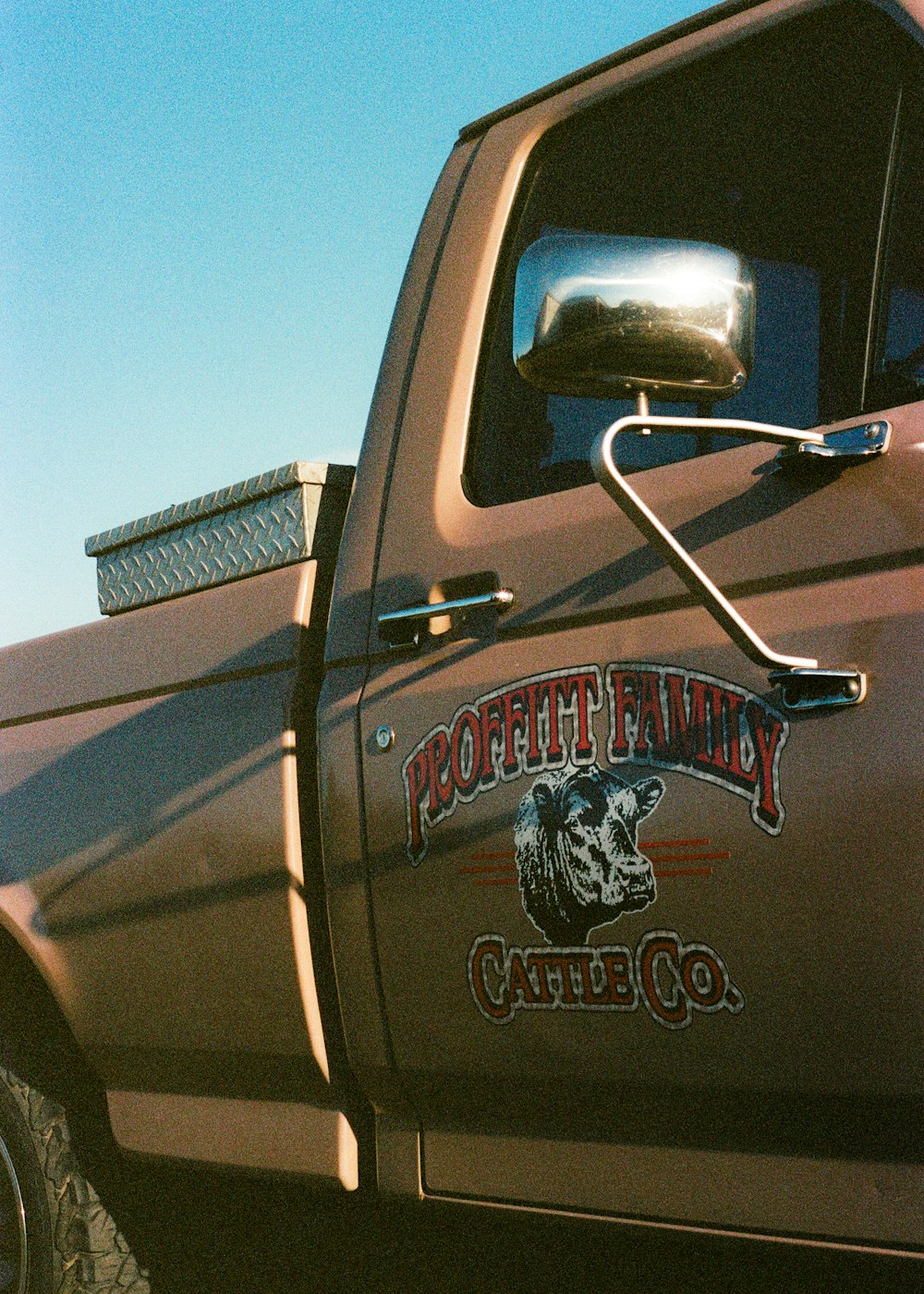 a brown truck with a logo on the side of it
