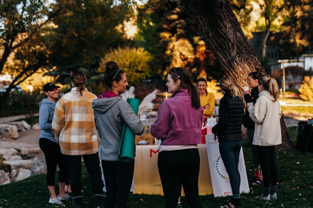 a group of people standing around a table