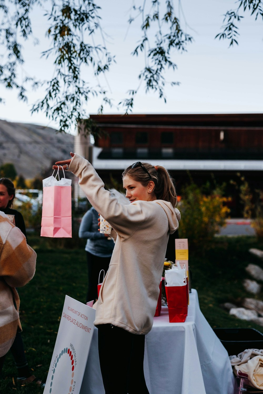 a woman holding up a pink shopping bag