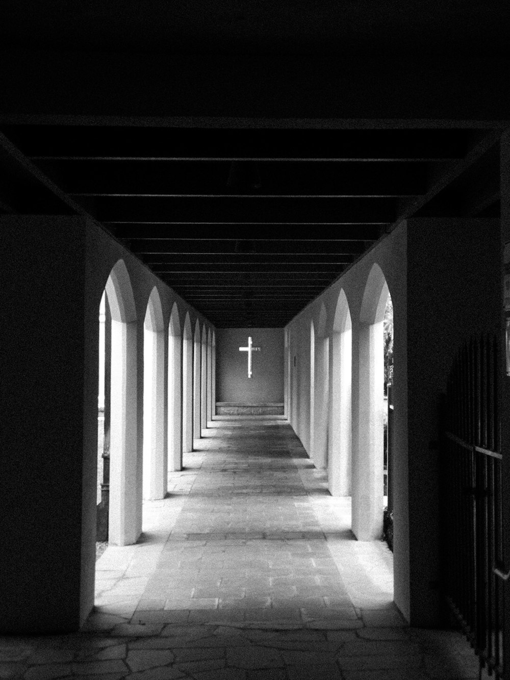 a black and white photo of a long hallway