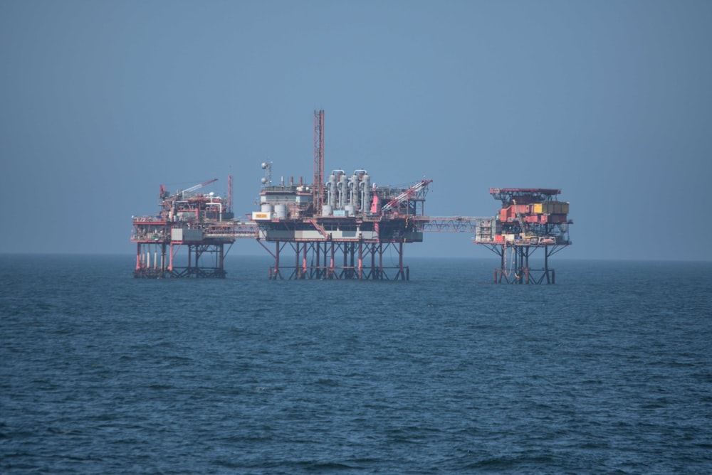 a group of oil rigs sitting on top of a large body of water