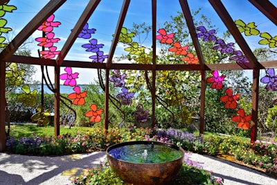 A vibrant garden scene featuring decorative stakes with colorful glass accents catching the sunlight.