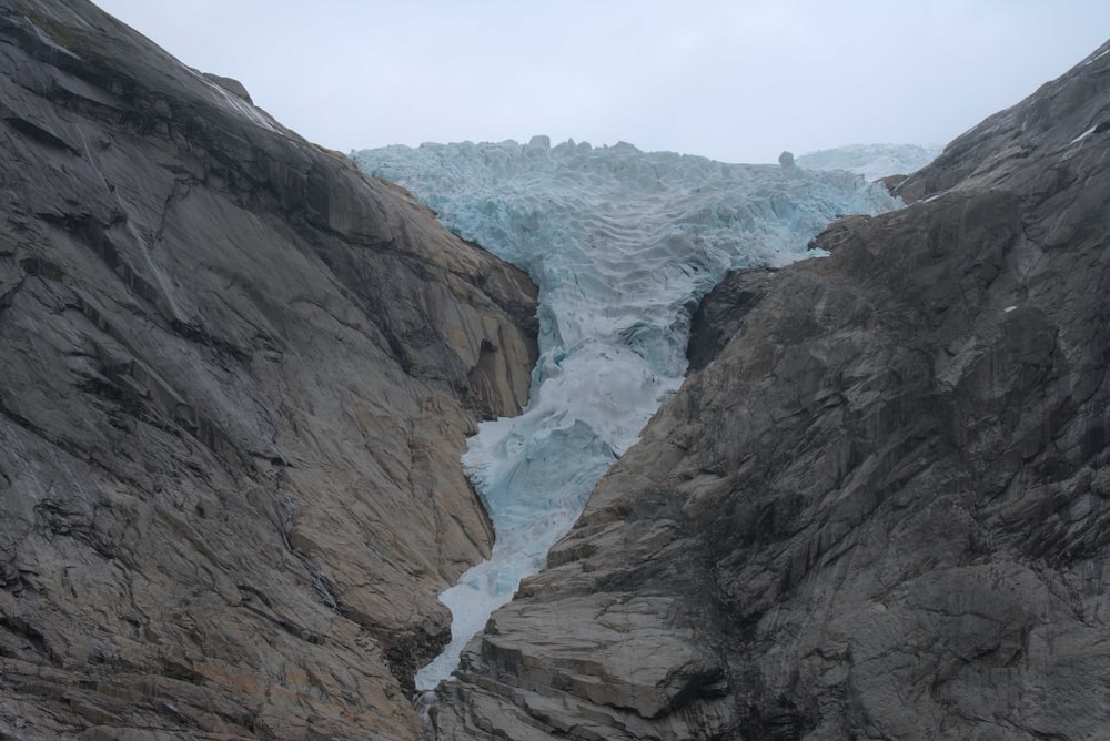 a large ice cave with a glacier in the background