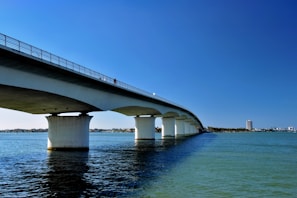 a bridge over a body of water under a blue sky