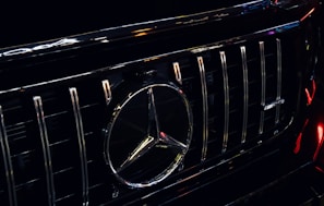 A close-up of a premium car's polished chrome grille and emblem