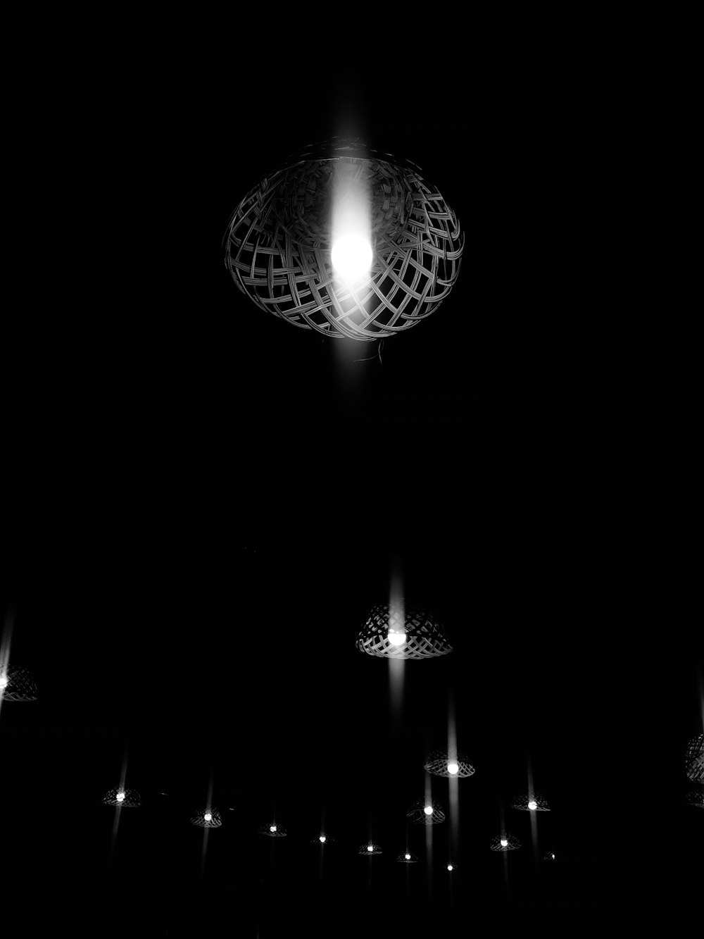 a black and white photo of lights in the dark